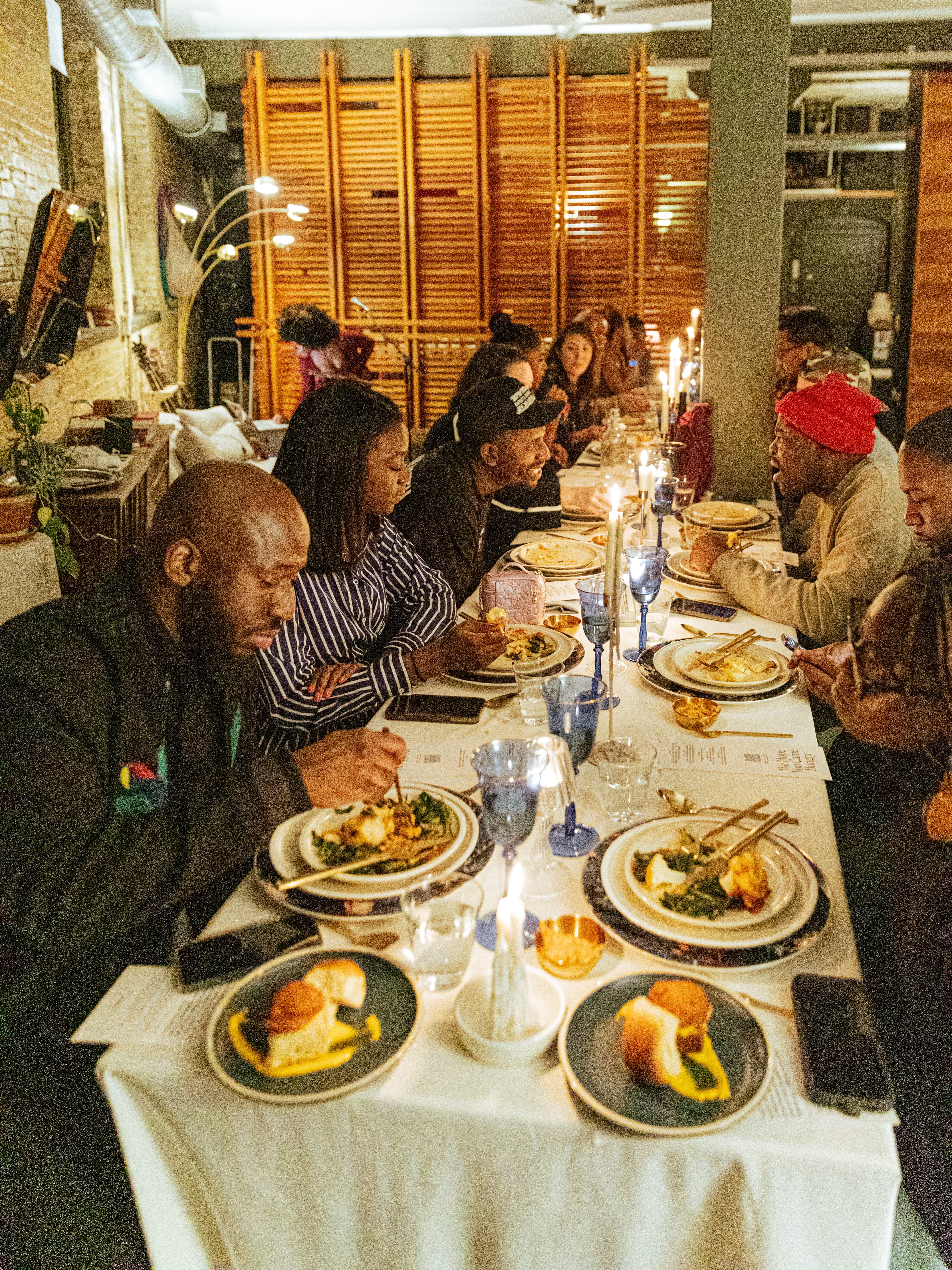 Guests enjoying a communal candlelit dinner