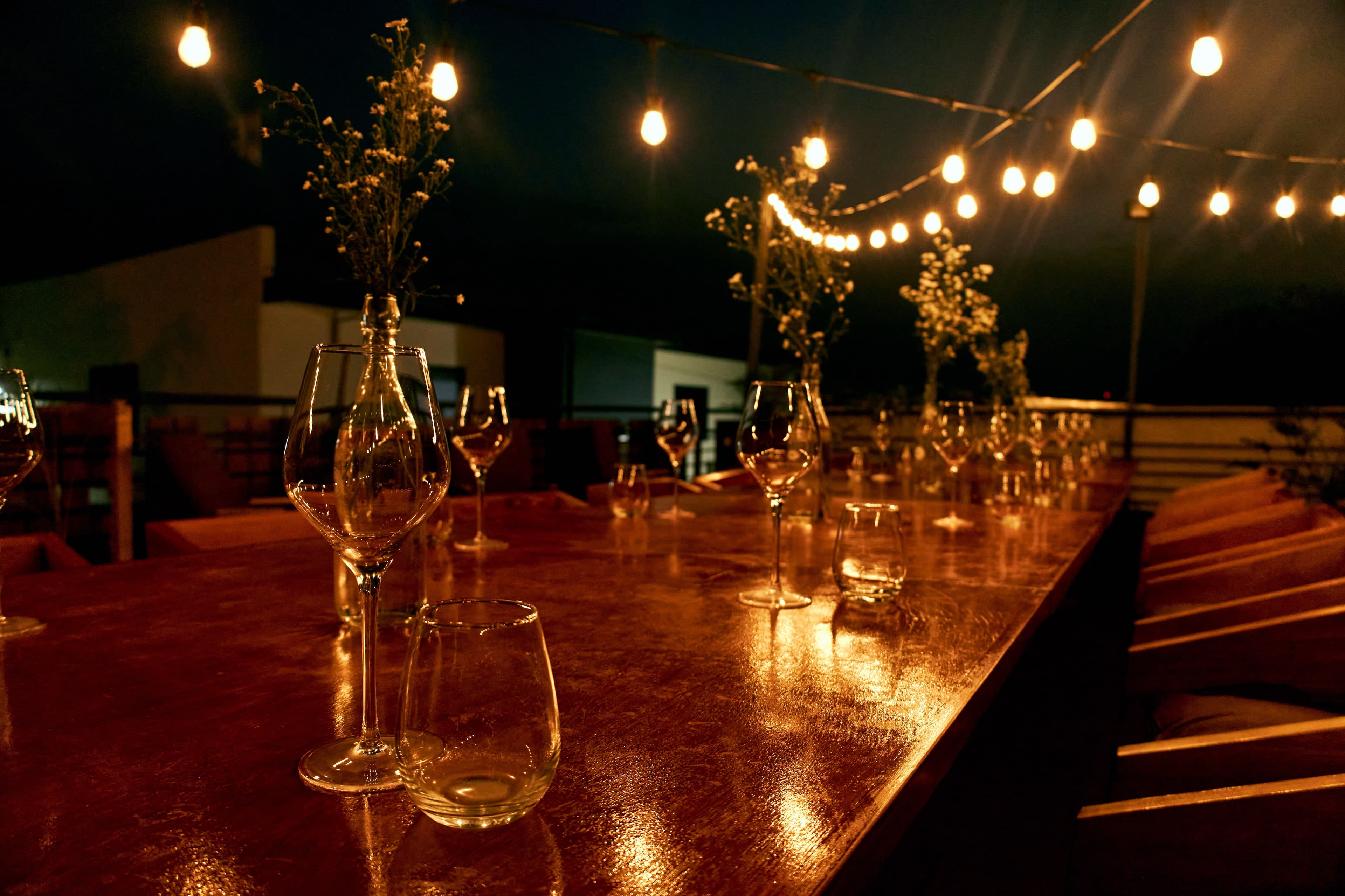 Elegant table setting with wine glasses and string lights