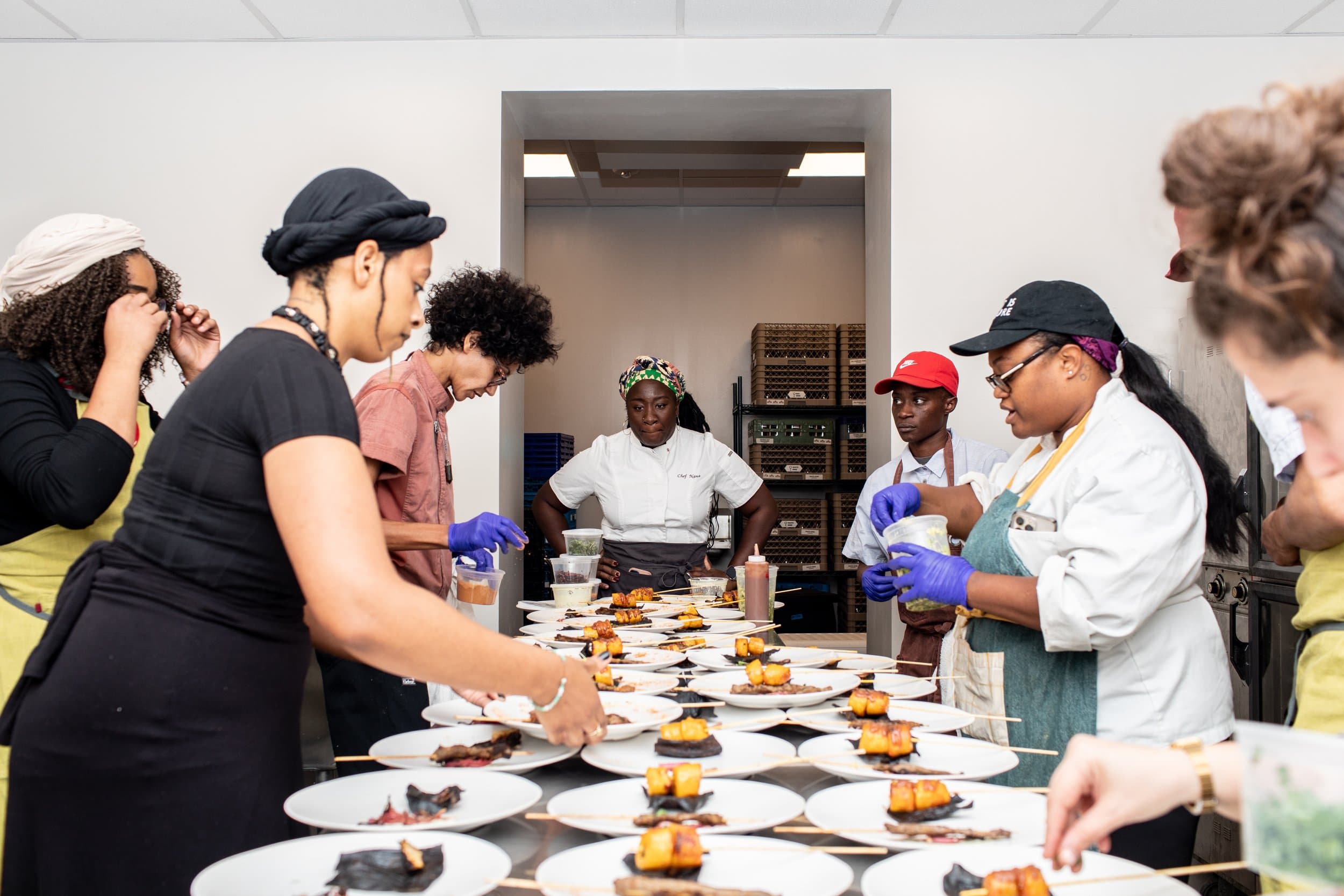 Chef Nana and team plating dishes